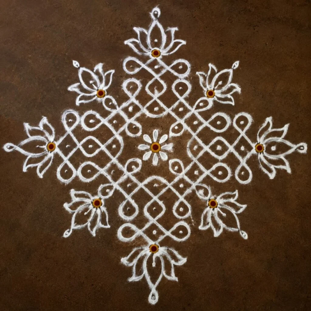 Red hand-embroidered saree with white Kolam patterns