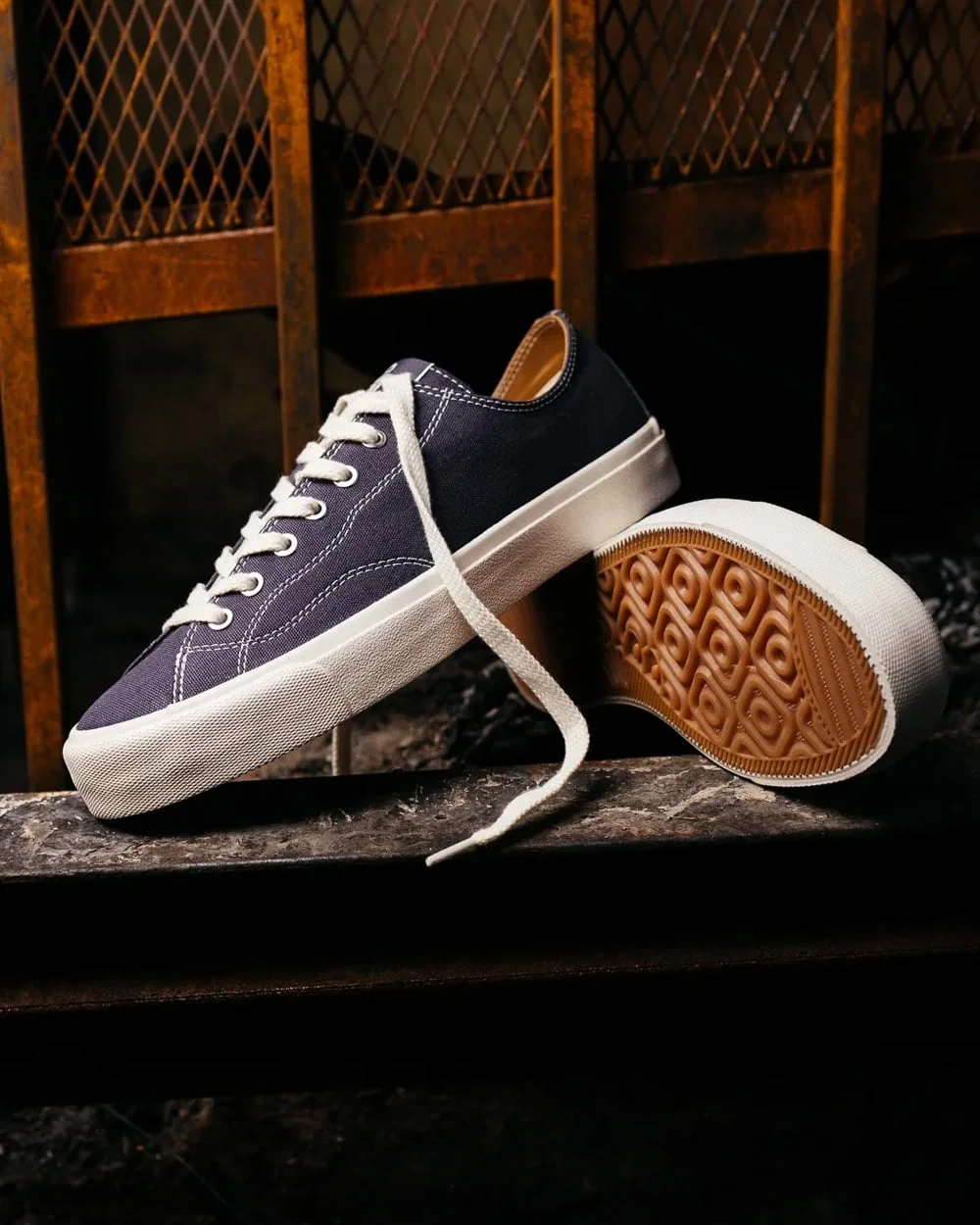 JAK leather sneaker in moody studio light, minimal design