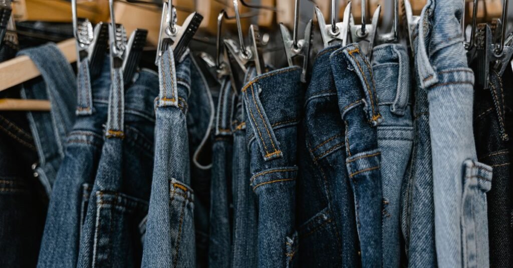 Fall fall clothing sale rack with jeans and tops on hangers