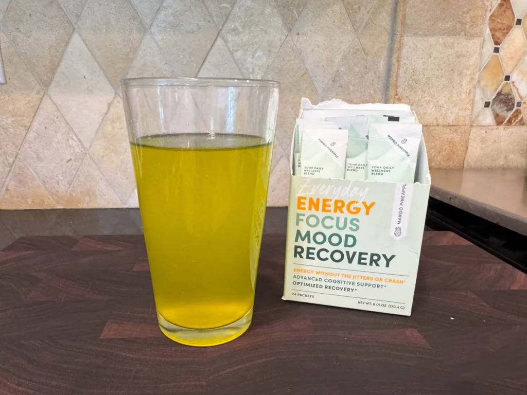 Glass of tropical energy drink beside MTE packets