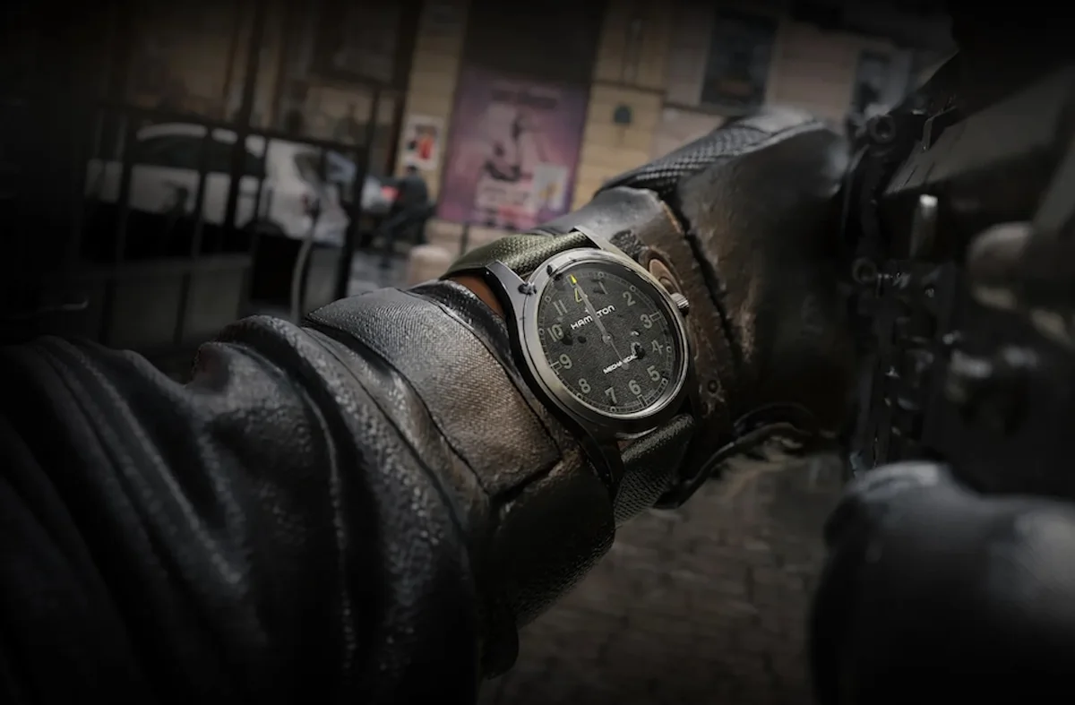 Hamilton Captain Price field watch on a gloved wrist in a city