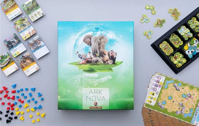 Ark Nova board game box with cards and tiles arranged around it
