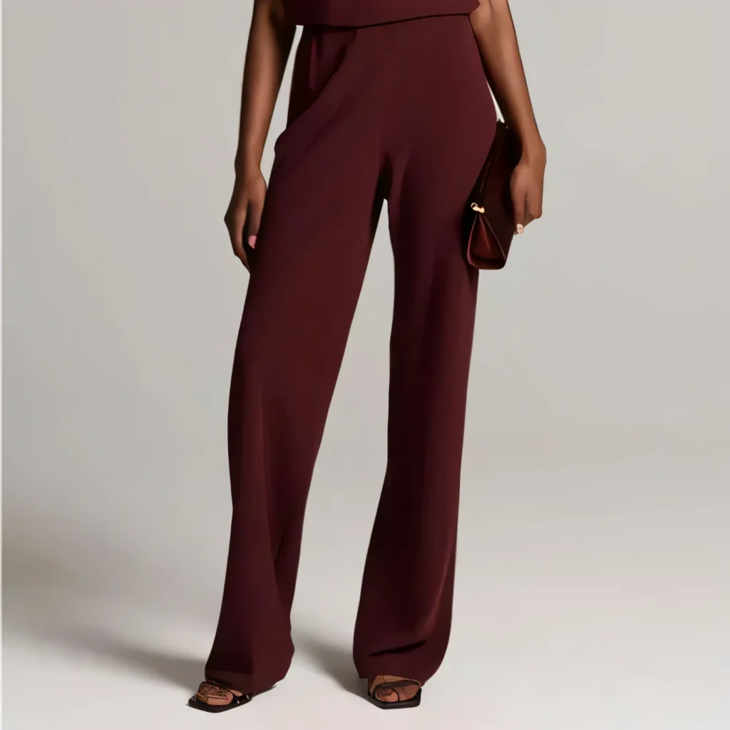 High-waisted burgundy wide-leg crepe trousers with strappy sandals