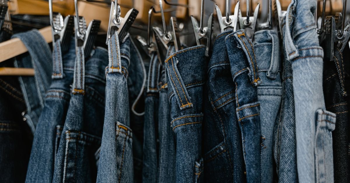 Fall fall clothing sale rack with jeans and tops on hangers