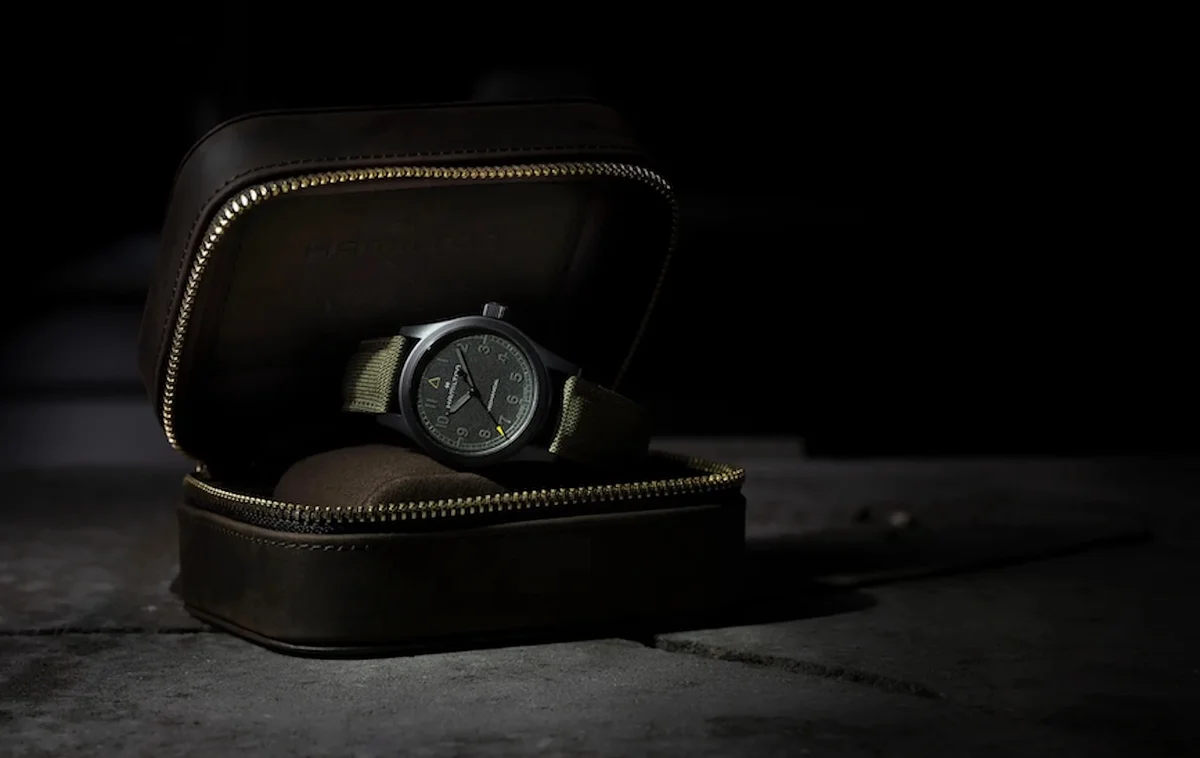Khaki Field watch resting inside its leather cigar-style presentation case